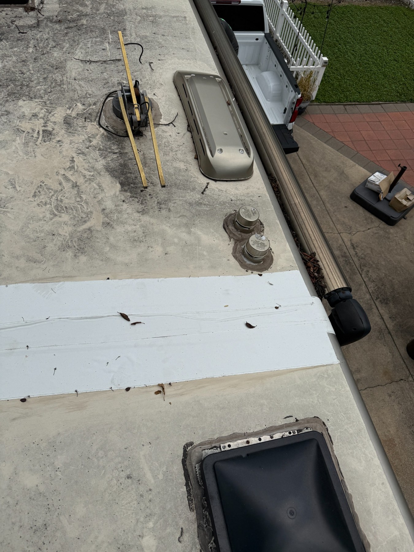 RV roof inspection showing aging roof surface, vents, roof air conditioner and skylight